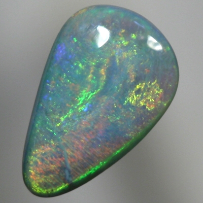 SOLID SEMI BLACK OPAL Glowing with bright greens over a beautiful blue